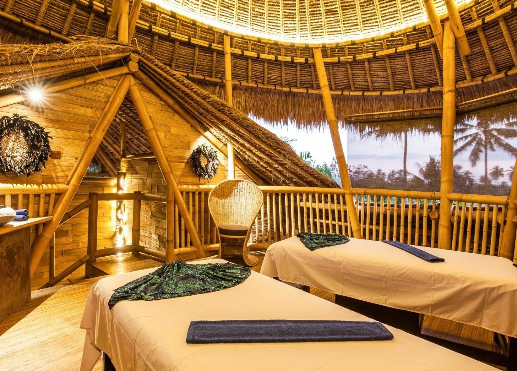 Serene bamboo spa room at Flying Bamboo Spa, Bali, Bali, ID with massage tables and natural decor.