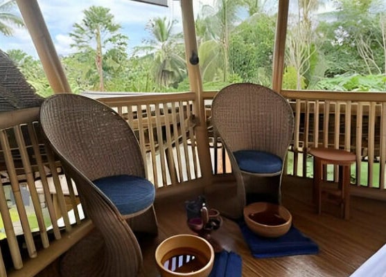 Relaxing bamboo spa setting at Flying Bamboo Spa, Bali, Bali, ID, featuring chairs and foot soak bowls.