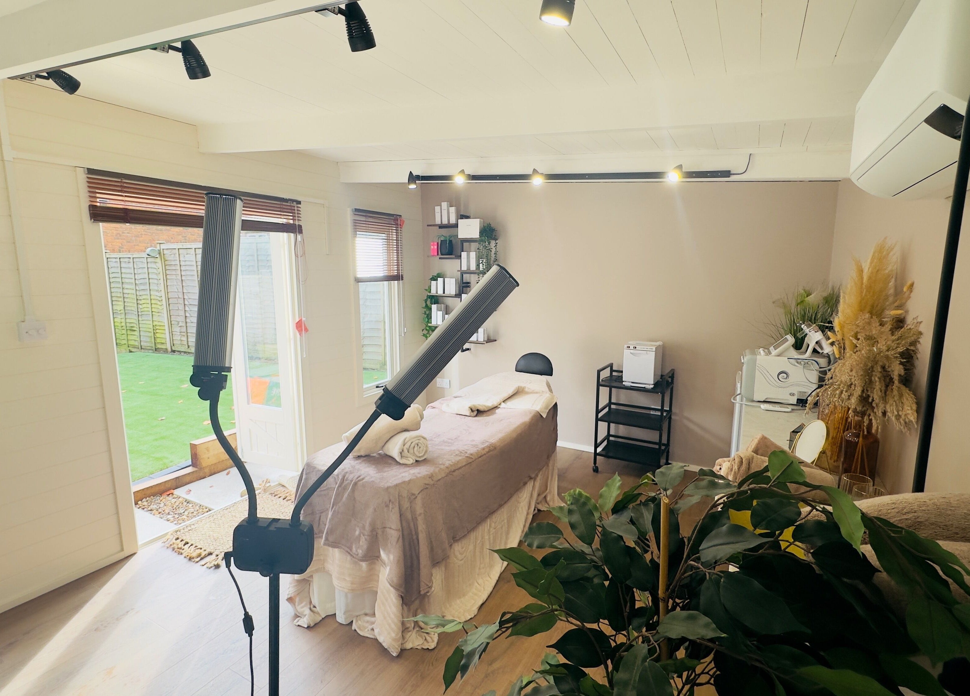 Elegant spa room at The Skin Chalet in Headley, England, GB with treatment bed and natural decor.