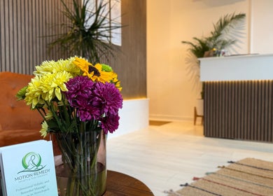 Welcoming reception of Motion Remedy, Hornchurch with vibrant flowers and modern decor.