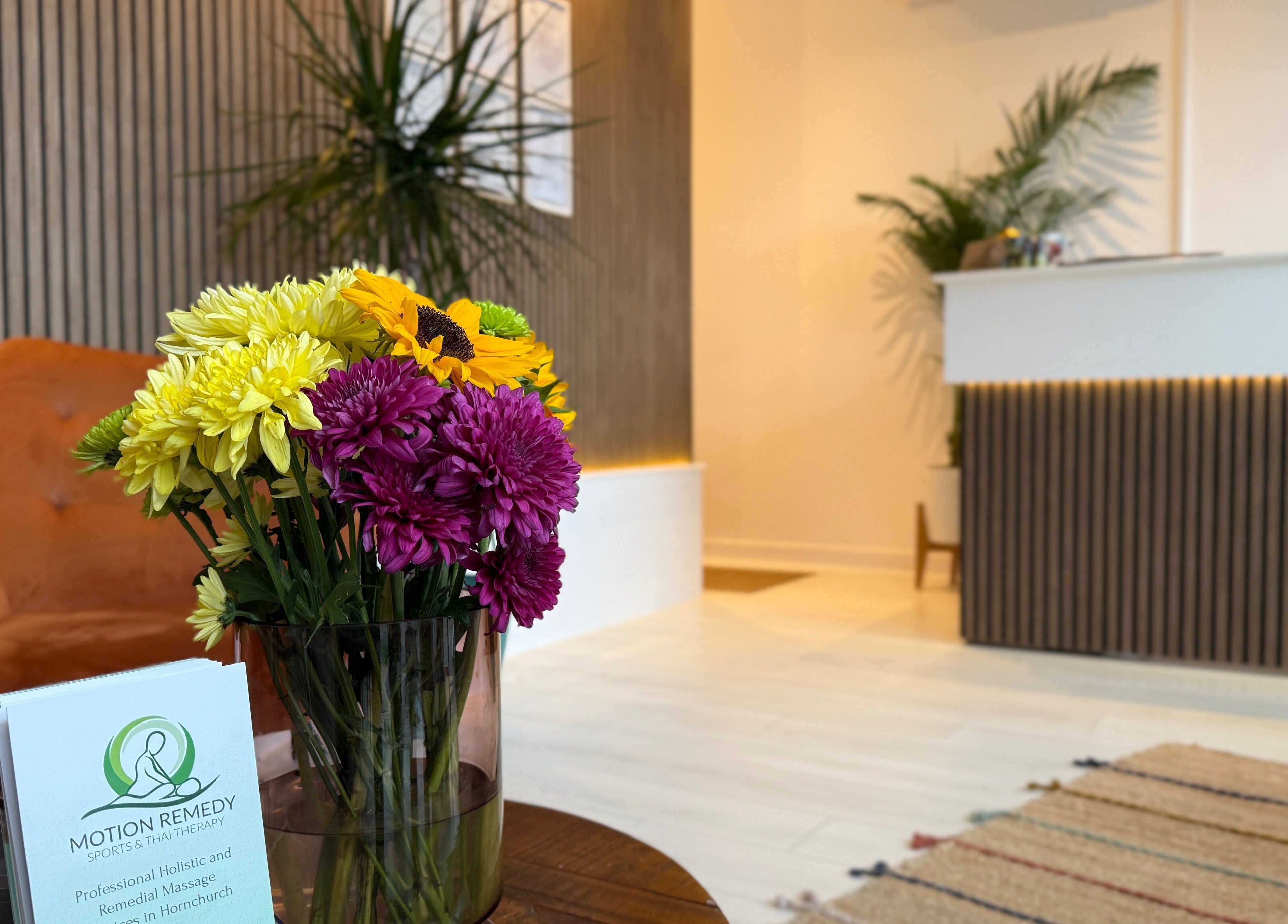 Welcoming reception of Motion Remedy, Hornchurch with vibrant flowers and modern decor.