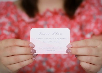 Inner Glow business card held in hand at Milton Keynes, England, GB. Skincare and facials specialist.