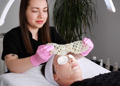 Beautician applying face mask at Inner Glow, Milton Keynes, England, GB. Relaxing skincare treatment in progress.
