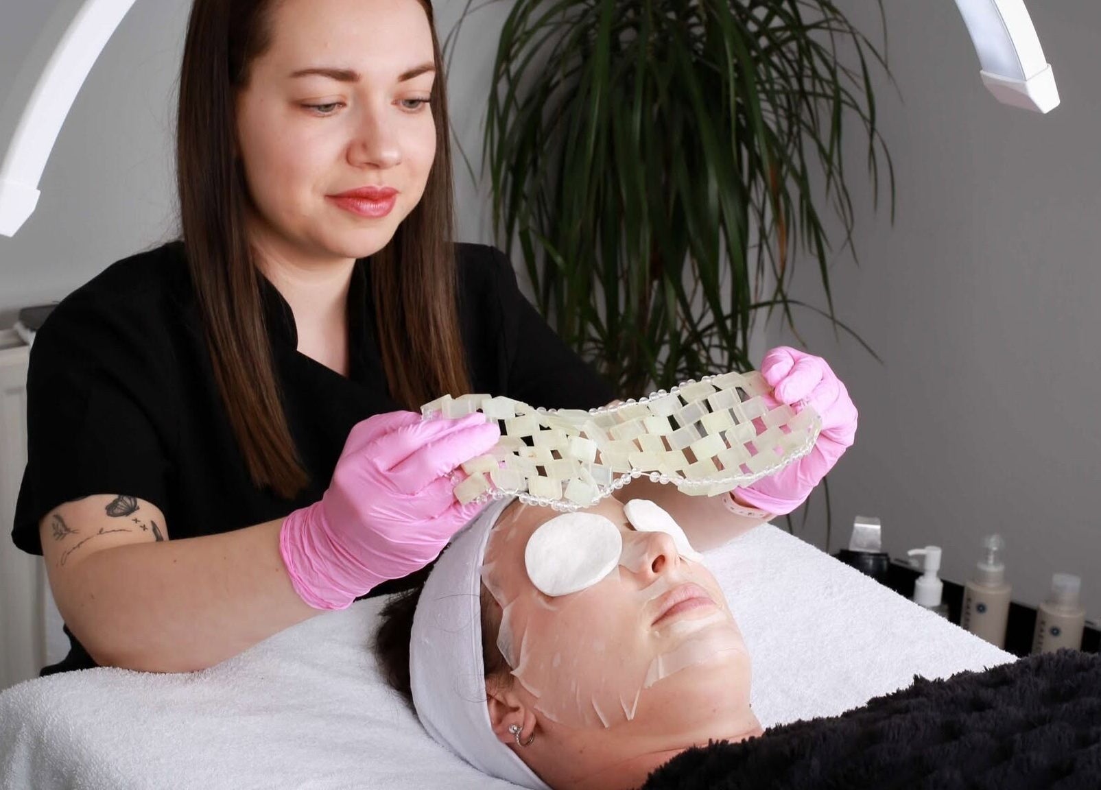 Beautician applying face mask at Inner Glow, Milton Keynes, England, GB. Relaxing skincare treatment in progress.