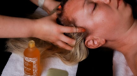 Relaxing head massage at Inner Glow in Milton Keynes, England, GB, featuring soothing hair oil treatment.