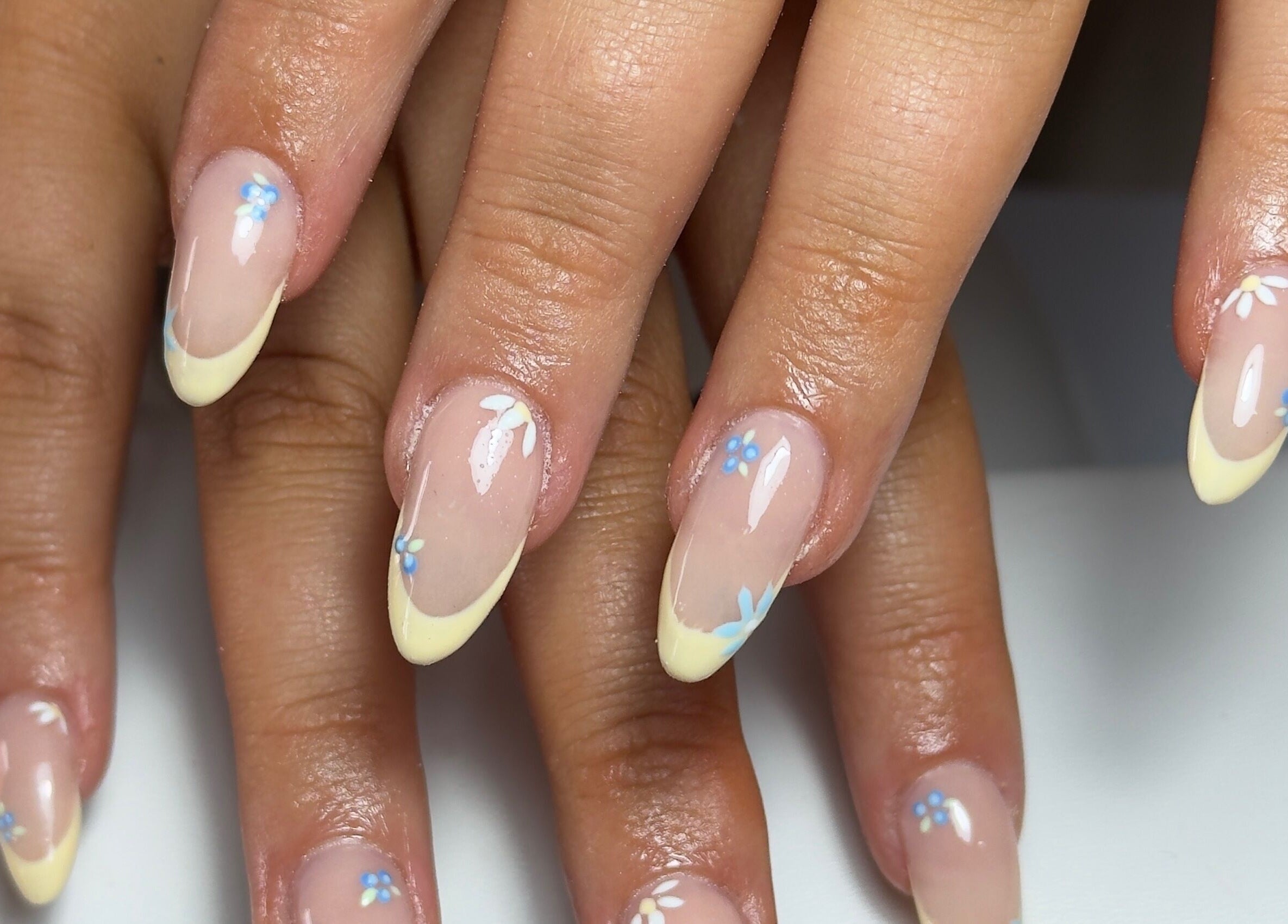 Elegant floral French tip manicure at Toni’s Beauty Lounge, Towcester, England, GB, showcasing stylish nail art.