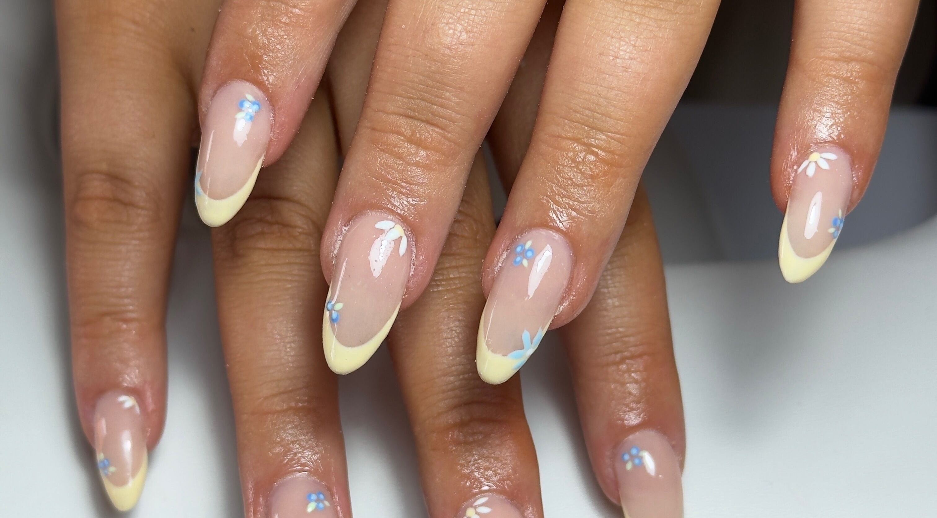 Elegant floral French tip manicure at Toni’s Beauty Lounge, Towcester, England, GB, showcasing stylish nail art.