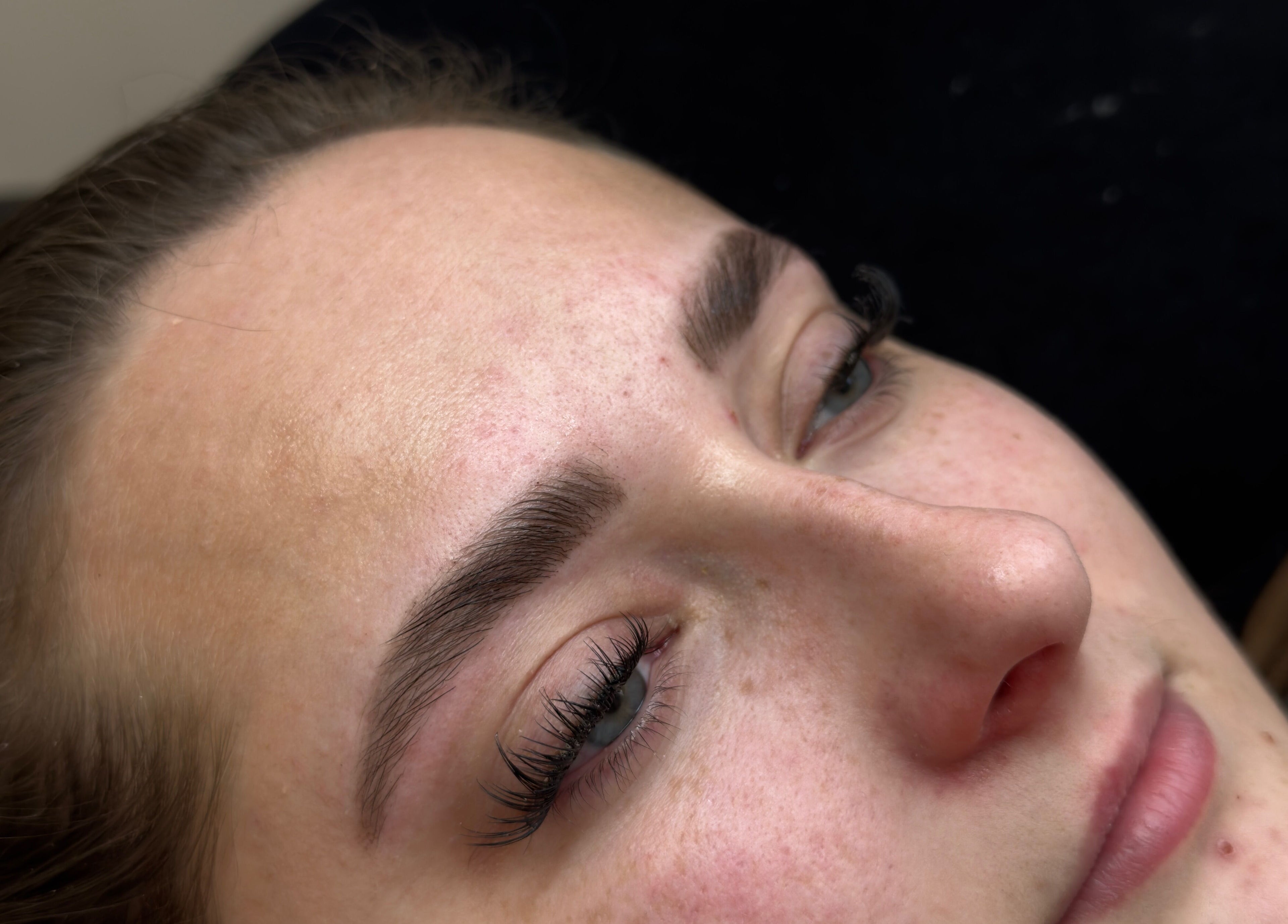 Close-up of a woman's enhanced eyebrows and eyelashes at Toni’s Beauty Lounge, Towcester, England, GB.