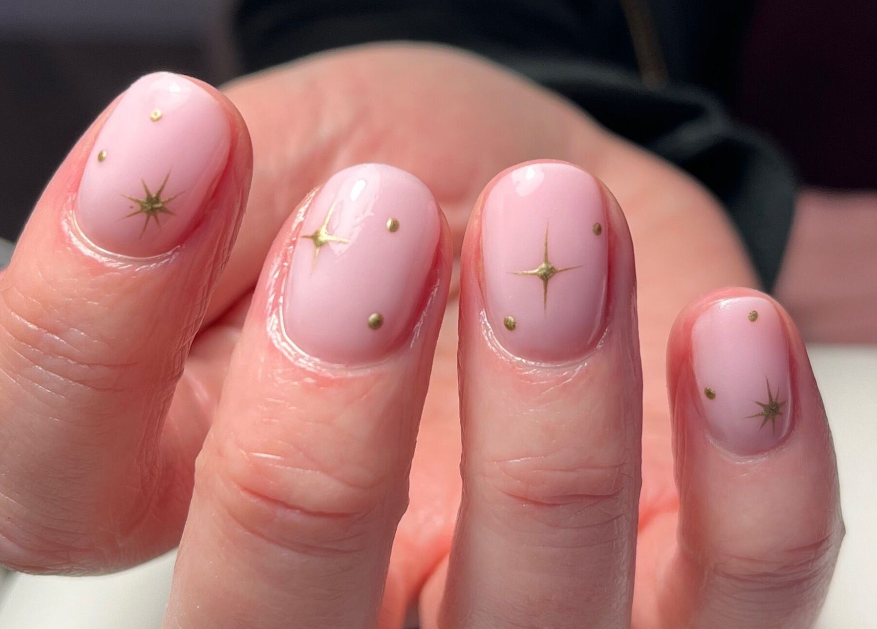 Elegant celestial nail art by Orla Nails & Beauty in Boyle, County Roscommon, IE, showcasing pink nails with golden stars.