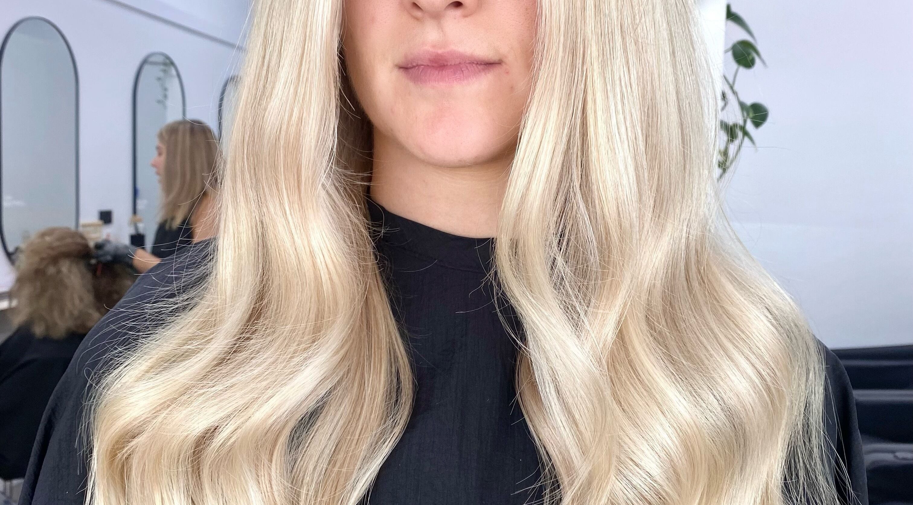 Blonde hair styled at The Hair Sorority, Nerang, Queensland, AU. Elegant waves create a chic look.
