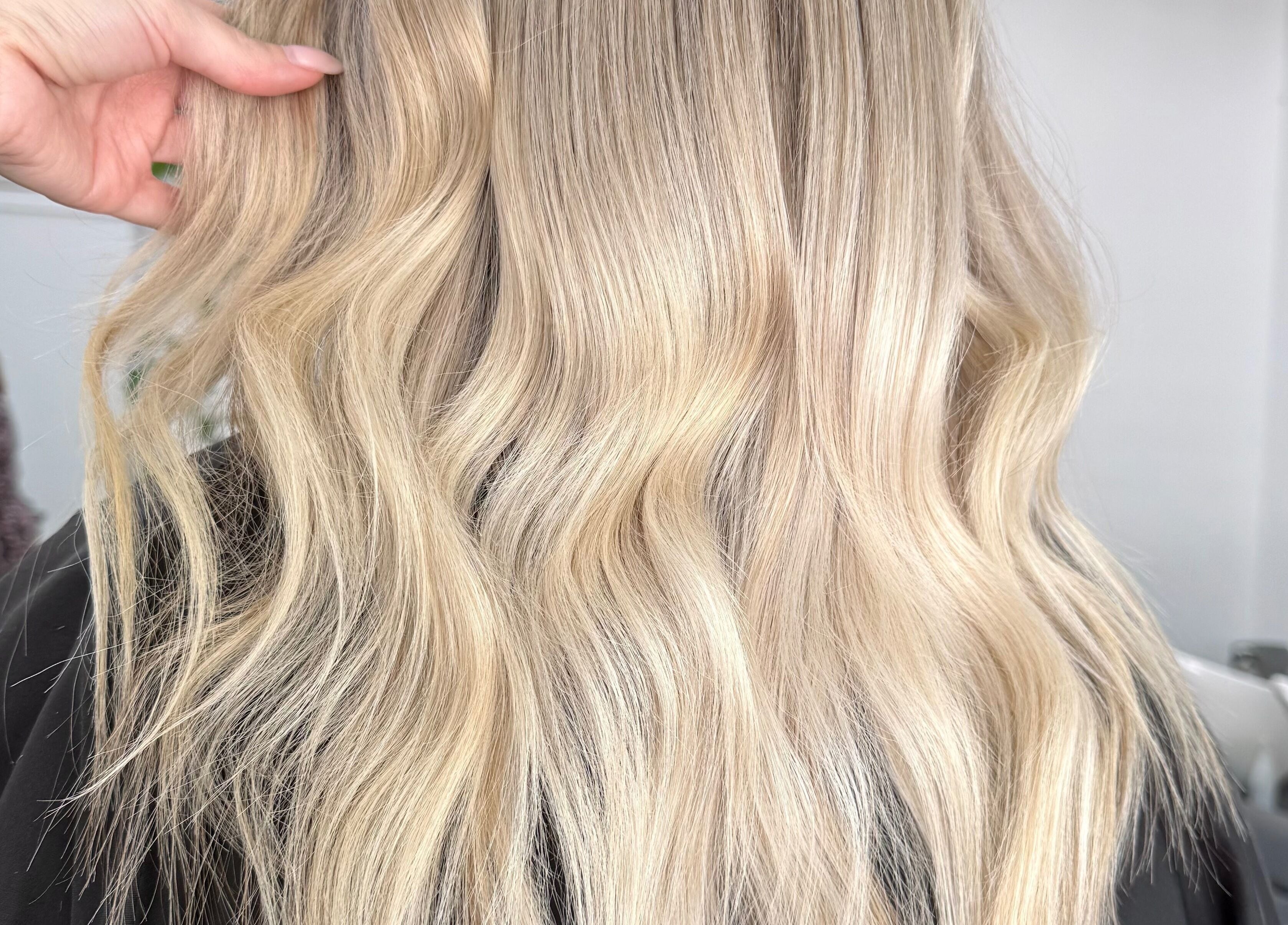 Blonde wavy hairstyle at The Hair Sorority in Nerang, Queensland, AU, showcasing expert hair coloring.