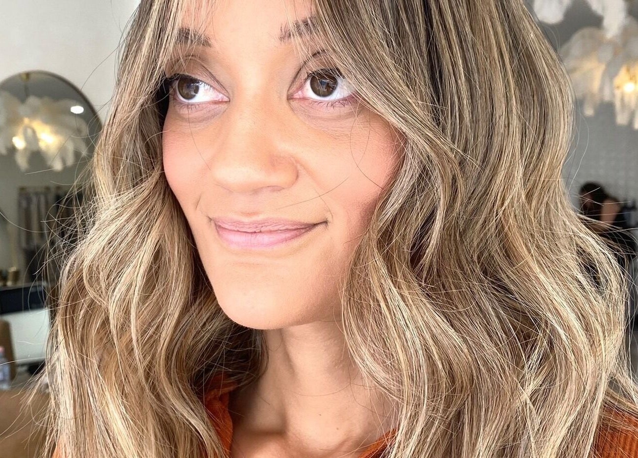 Smiling woman with long wavy hair at The Hair Sorority, Nerang, Queensland, AU.