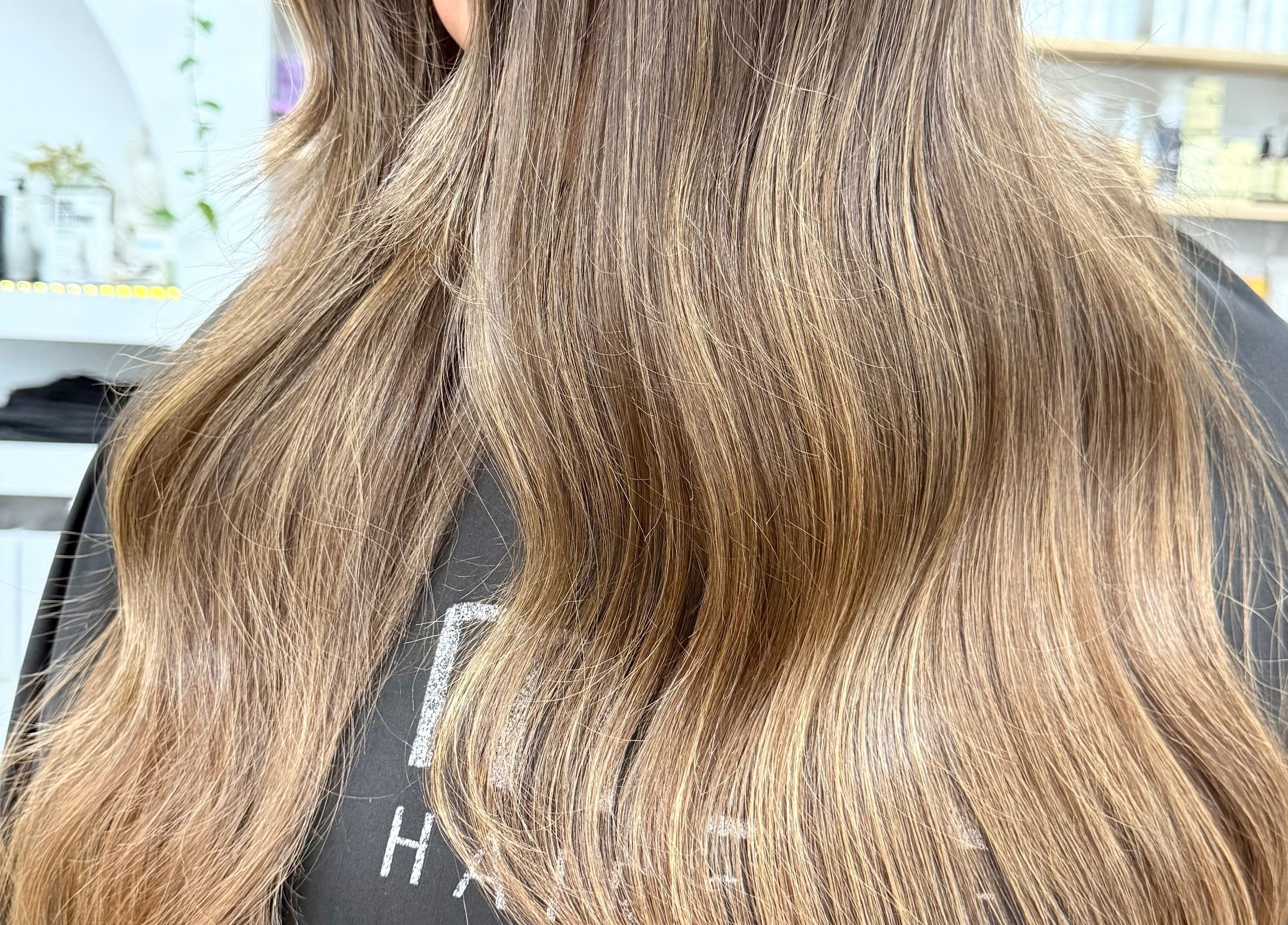 Smooth, flowing hair styled at The Hair Sorority, Nerang, Queensland, AU, showcasing vibrant highlights.