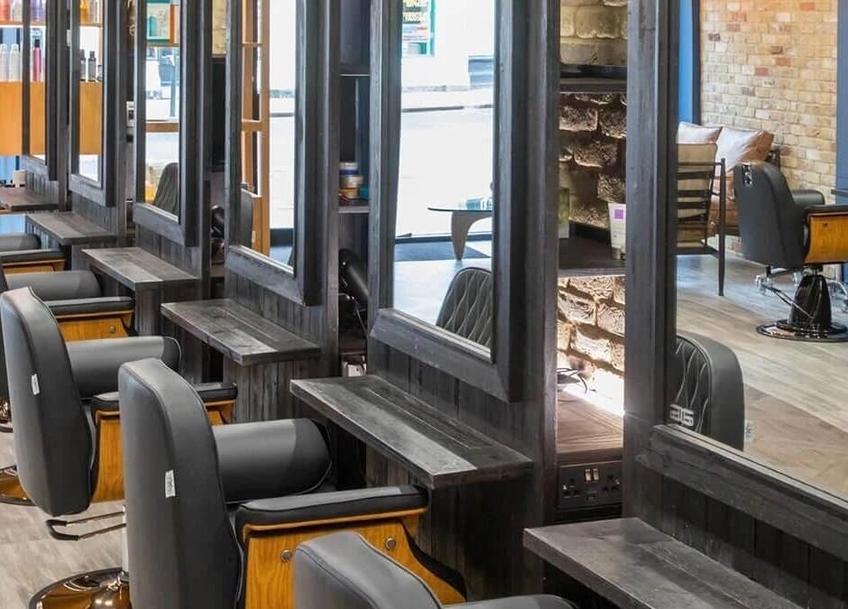 Chic interior of Rachael the Barber at Aiden Garlington Hair Design in Bristol, England, GB, showcasing modern styling chairs.