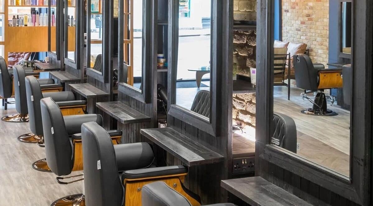 Chic interior of Rachael the Barber at Aiden Garlington Hair Design in Bristol, England, GB, showcasing modern styling chairs.