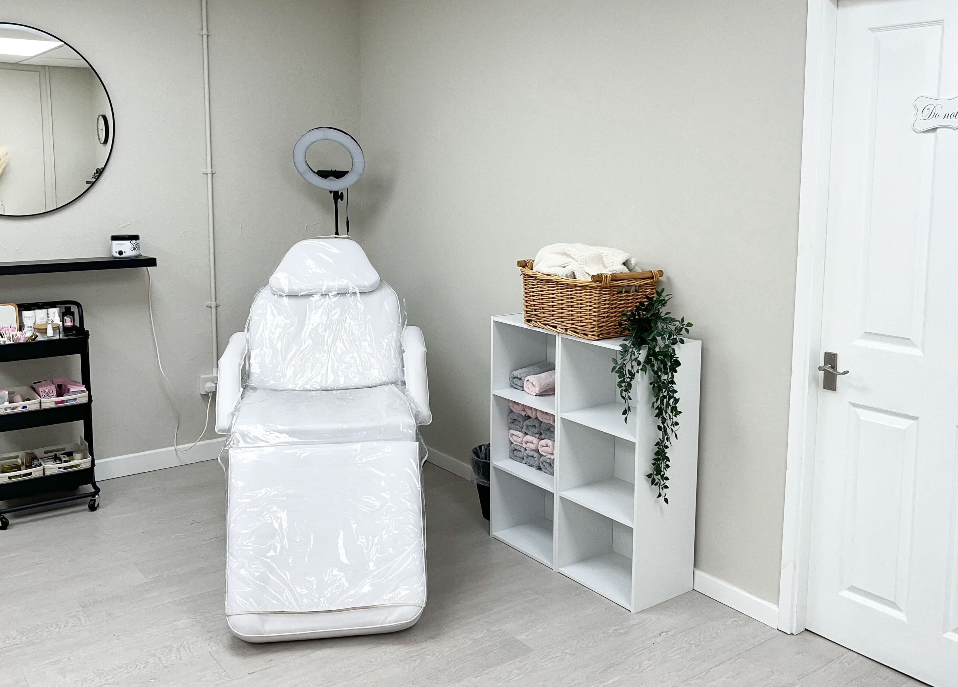 Calm treatment room at The Glam Studio, Farsley, Leeds, England, GB featuring a sleek white chair.