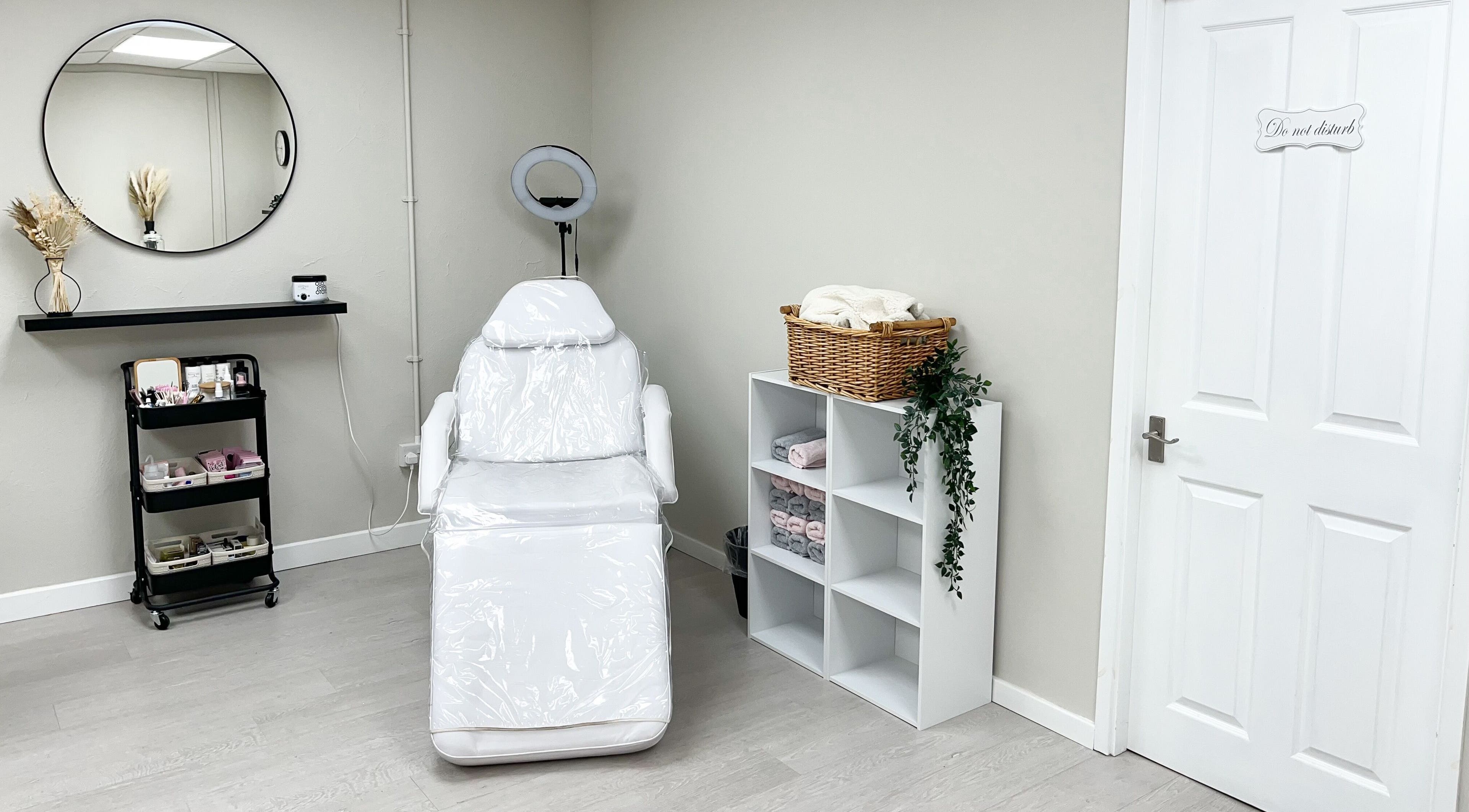 Calm treatment room at The Glam Studio, Farsley, Leeds, England, GB featuring a sleek white chair.