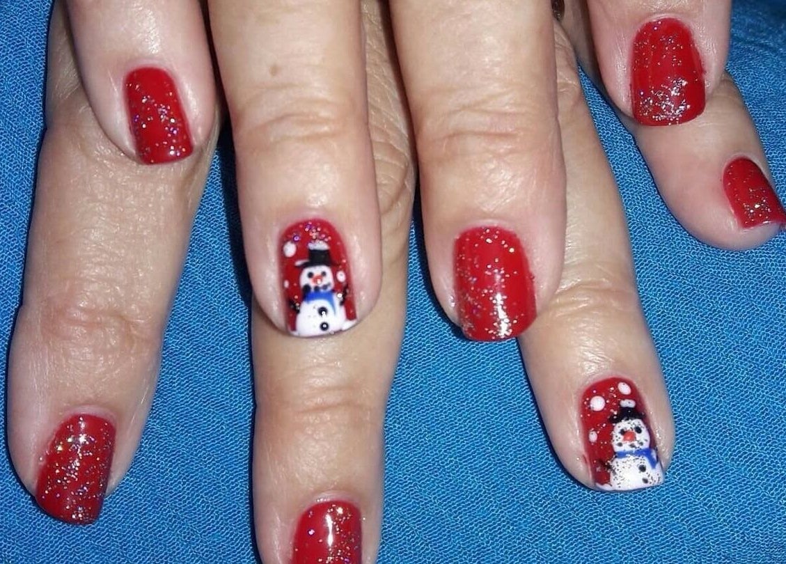 Red glitter nail art with snowman design at Bisou Spa, Hastings, Christ Church, BB.