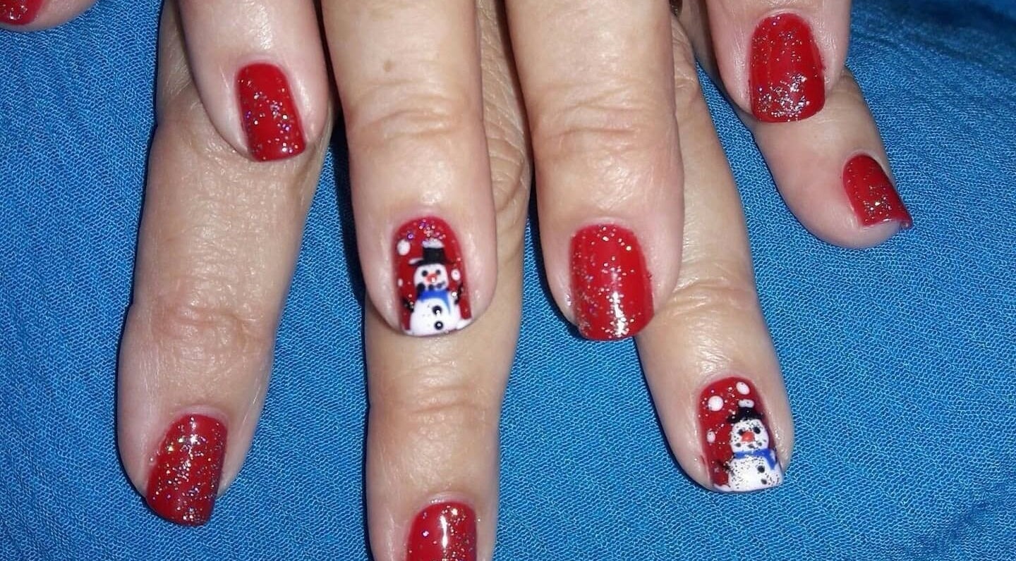Red glitter nail art with snowman design at Bisou Spa, Hastings, Christ Church, BB.