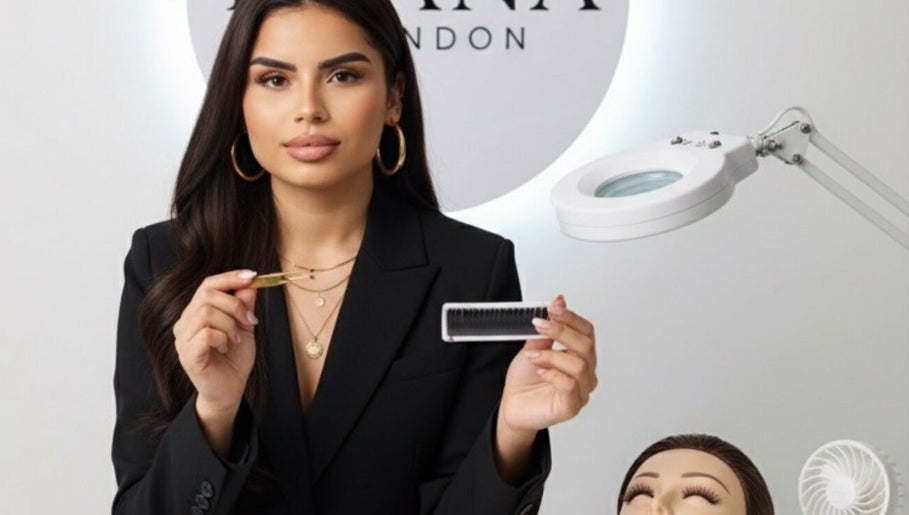 Professional demonstrating eyelash tools at Byana London, Enfield, England, GB, enhances natural beauty with skill.