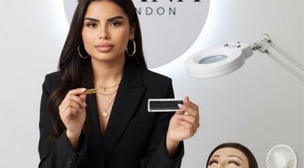 Professional demonstrating eyelash tools at Byana London, Enfield, England, GB, enhances natural beauty with skill.