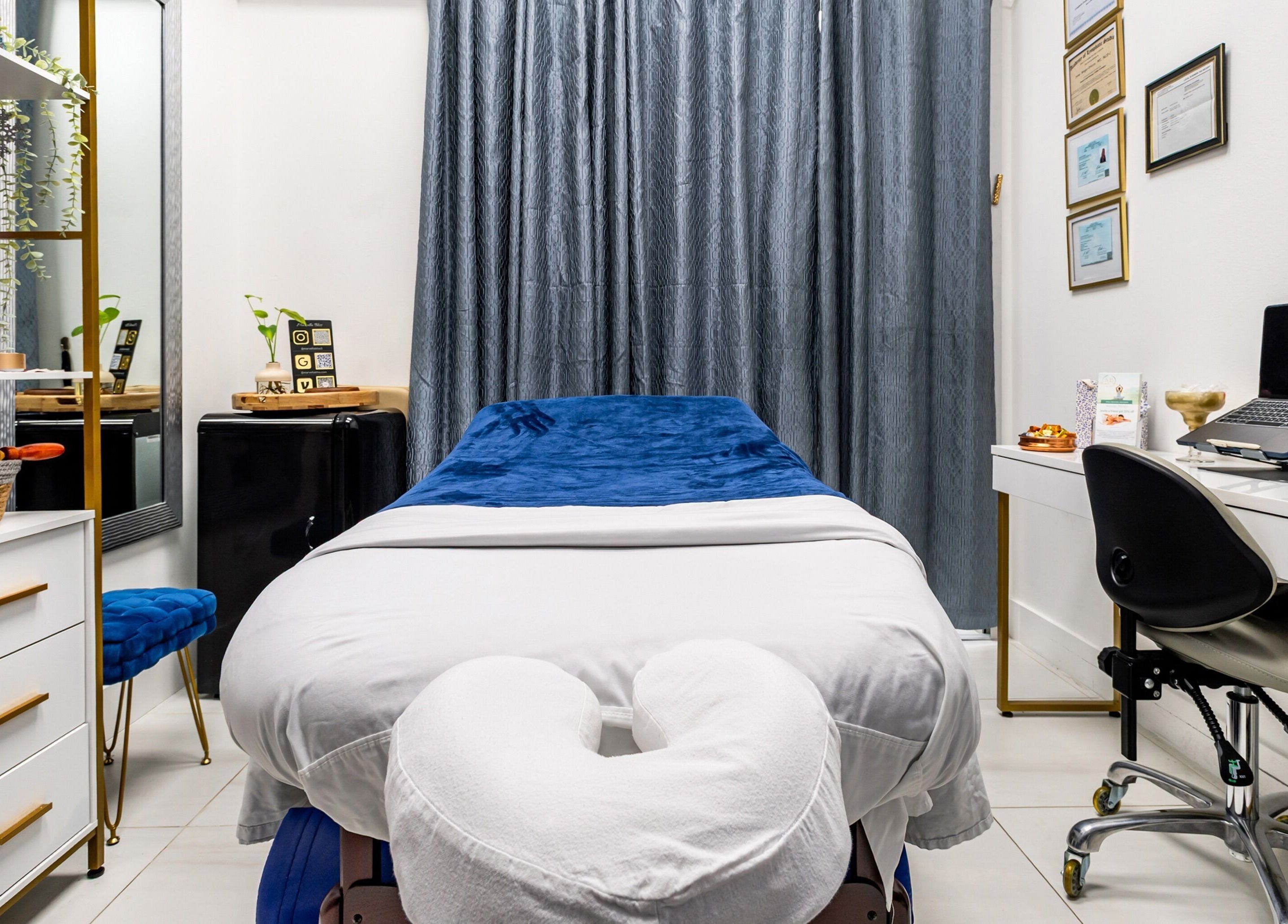 Serene massage room at Marvella Bliss, Pembroke Pines, Florida, US, featuring cozy table and elegant decor.