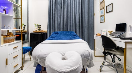 Serene massage room at Marvella Bliss, Pembroke Pines, Florida, US, featuring cozy table and elegant decor.