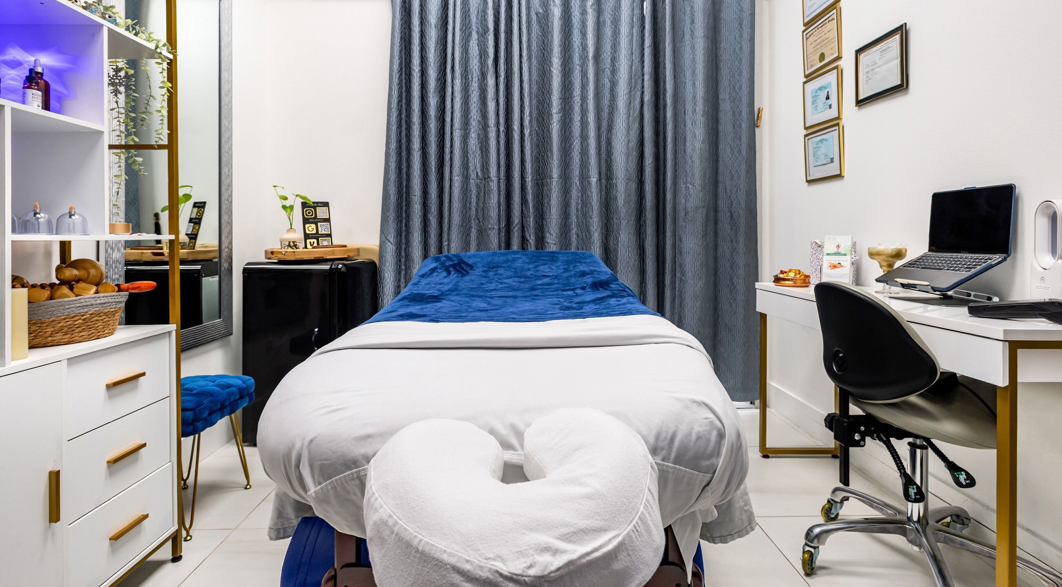 Serene massage room at Marvella Bliss, Pembroke Pines, Florida, US, featuring cozy table and elegant decor.