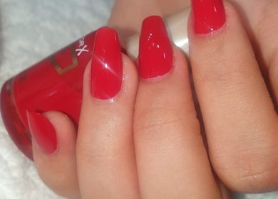 Vibrant red nail polish application at Lilian Beauty Salon, Juffair, Bahrain, BH.