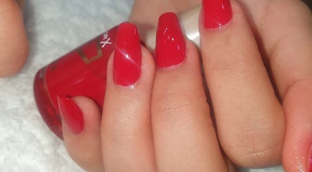Vibrant red nail polish application at Lilian Beauty Salon, Juffair, Bahrain, BH.