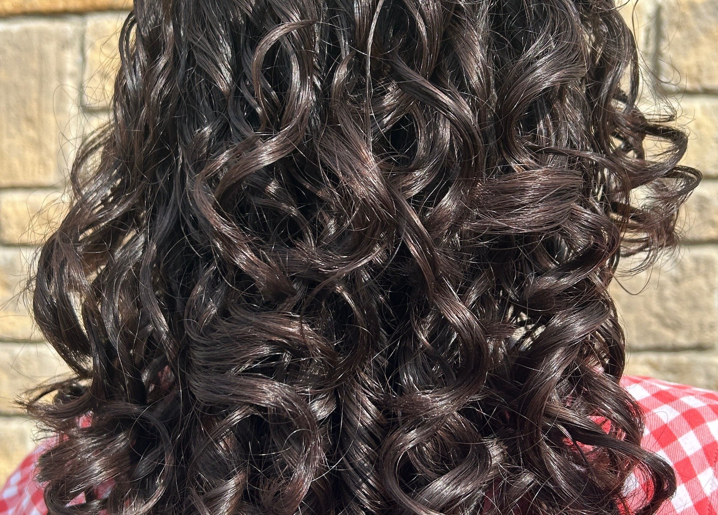 Beautiful curly hair styled at Hair by Éloise, Lyneham, England, GB, perfect for any occasion.