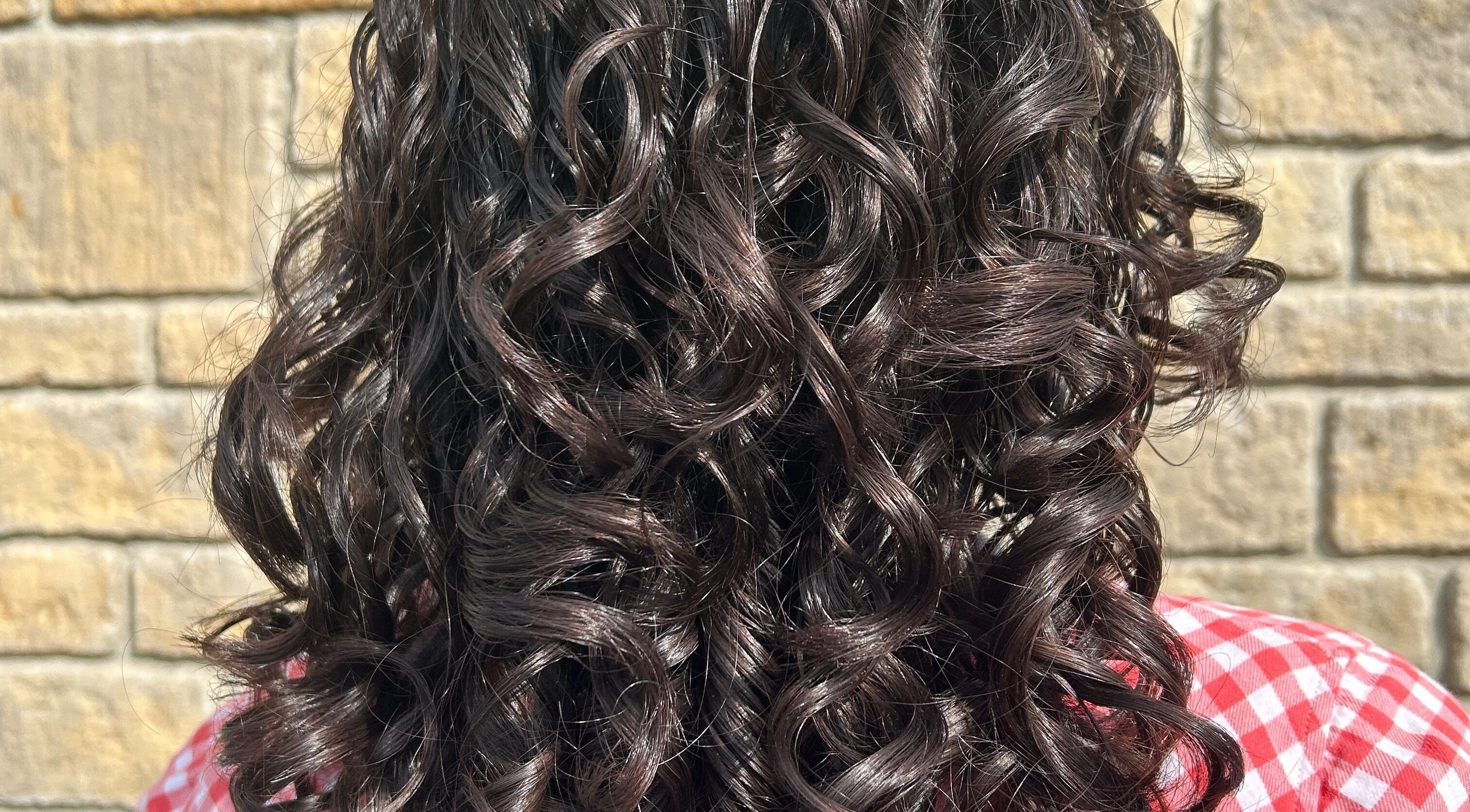 Beautiful curly hair styled at Hair by Éloise, Lyneham, England, GB, perfect for any occasion.