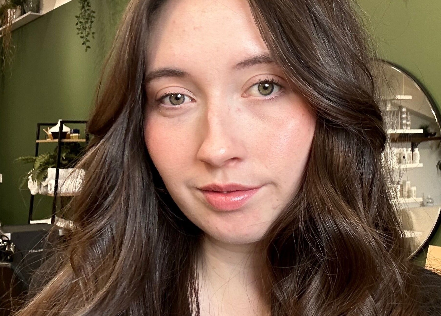 Stylish woman in Hair by Éloise salon, Lyneham, England, GB, showcasing glossy brown waves.