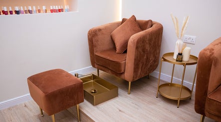 Elegant pedicure chair at Krasa Facial Center, Dubai, AE, with nail polishes and side table decor.