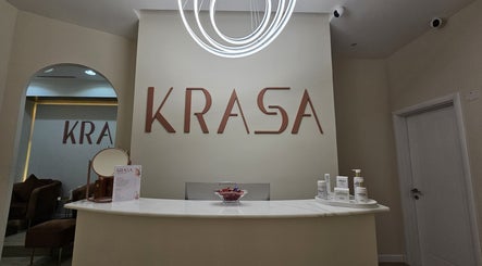 Krasa Facial Center reception area in Dubai, AE, showcasing modern decor and skincare products.
