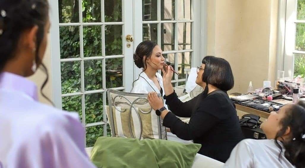 Makeup artist at Makeup by Ameerah perfects a bride's look in Cape Town, Western Cape, ZA.