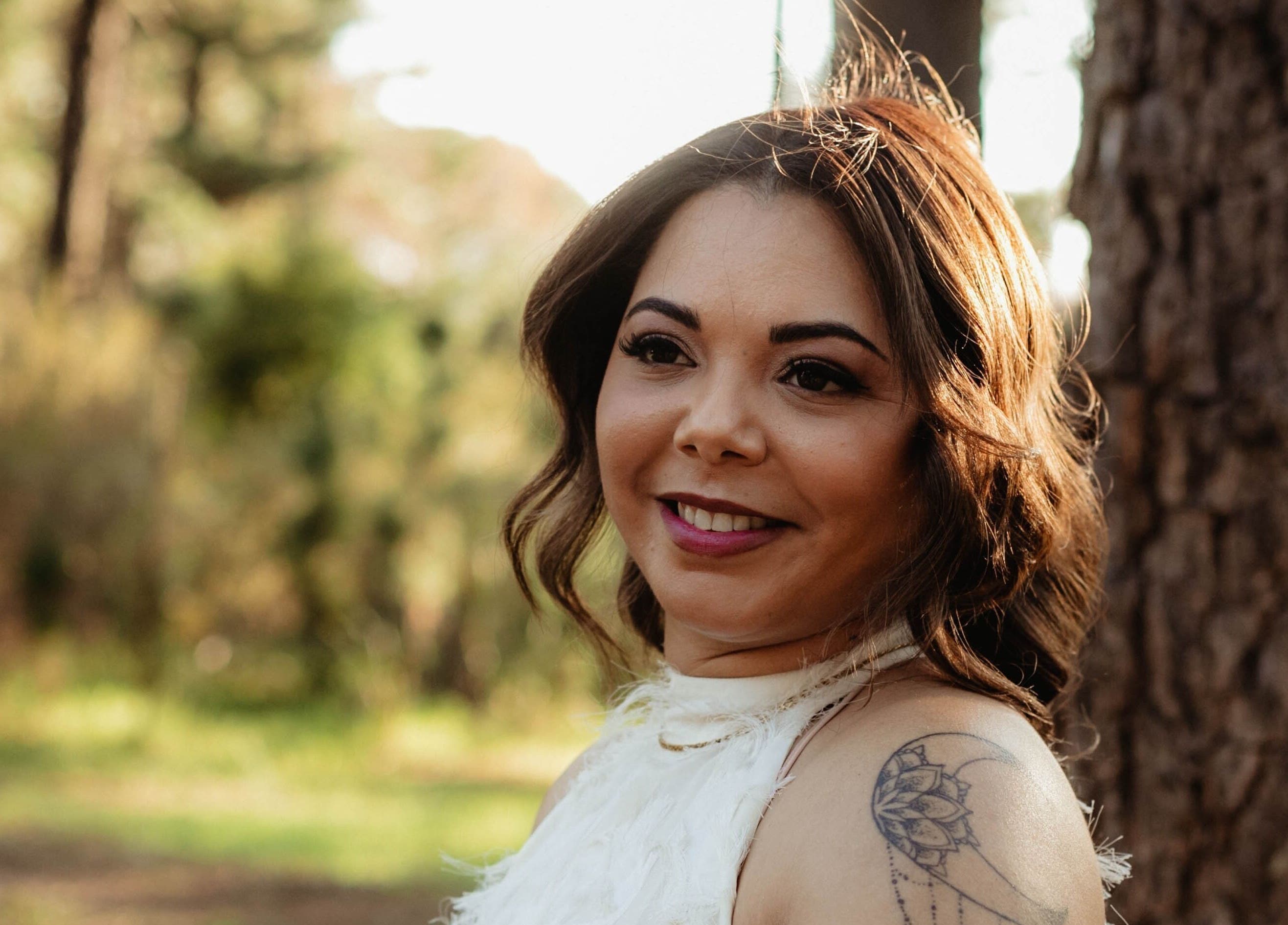 Smiling woman with elegant makeup by Makeup by Ameerah in Cape Town, Western Cape, ZA outdoor setting.