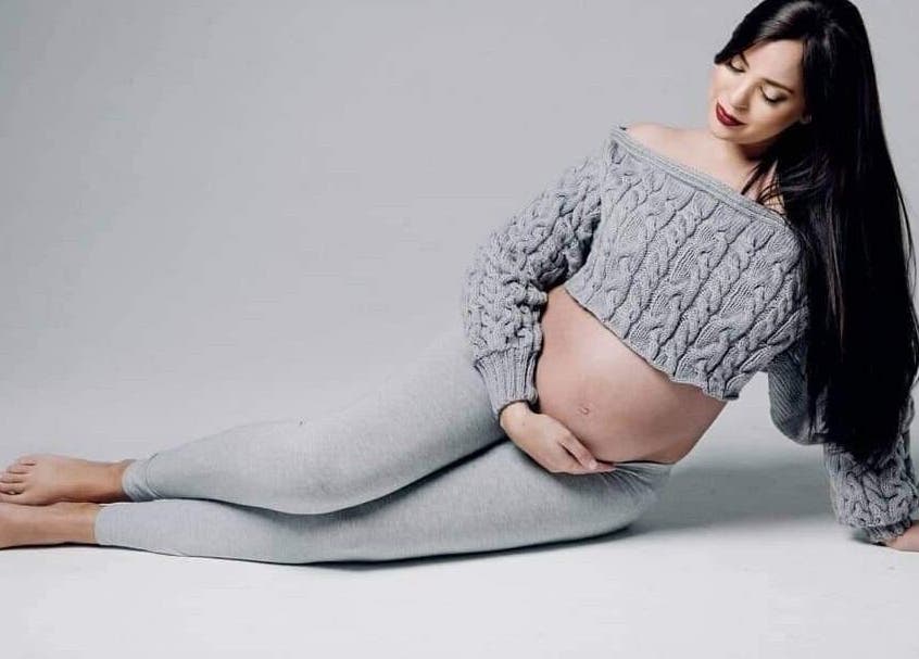 Pregnant woman in cozy sweater at Makeup by Ameerah, Cape Town, Western Cape, ZA.