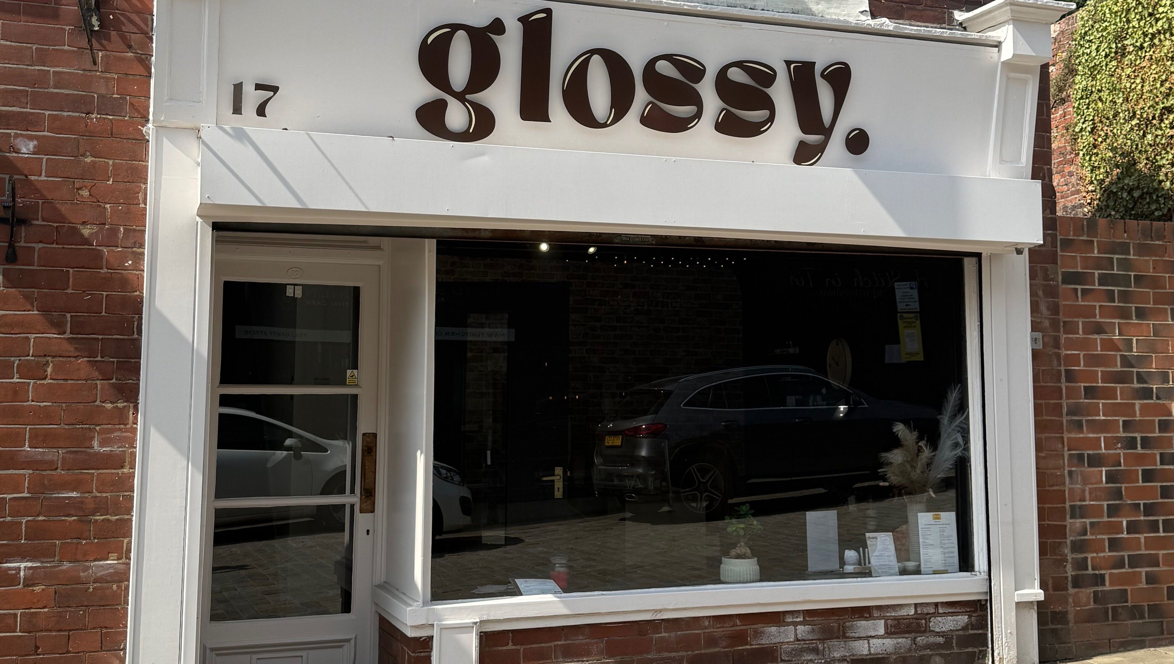 Front view of Glossy salon in Pontefract, England, GB with a stylish modern exterior.