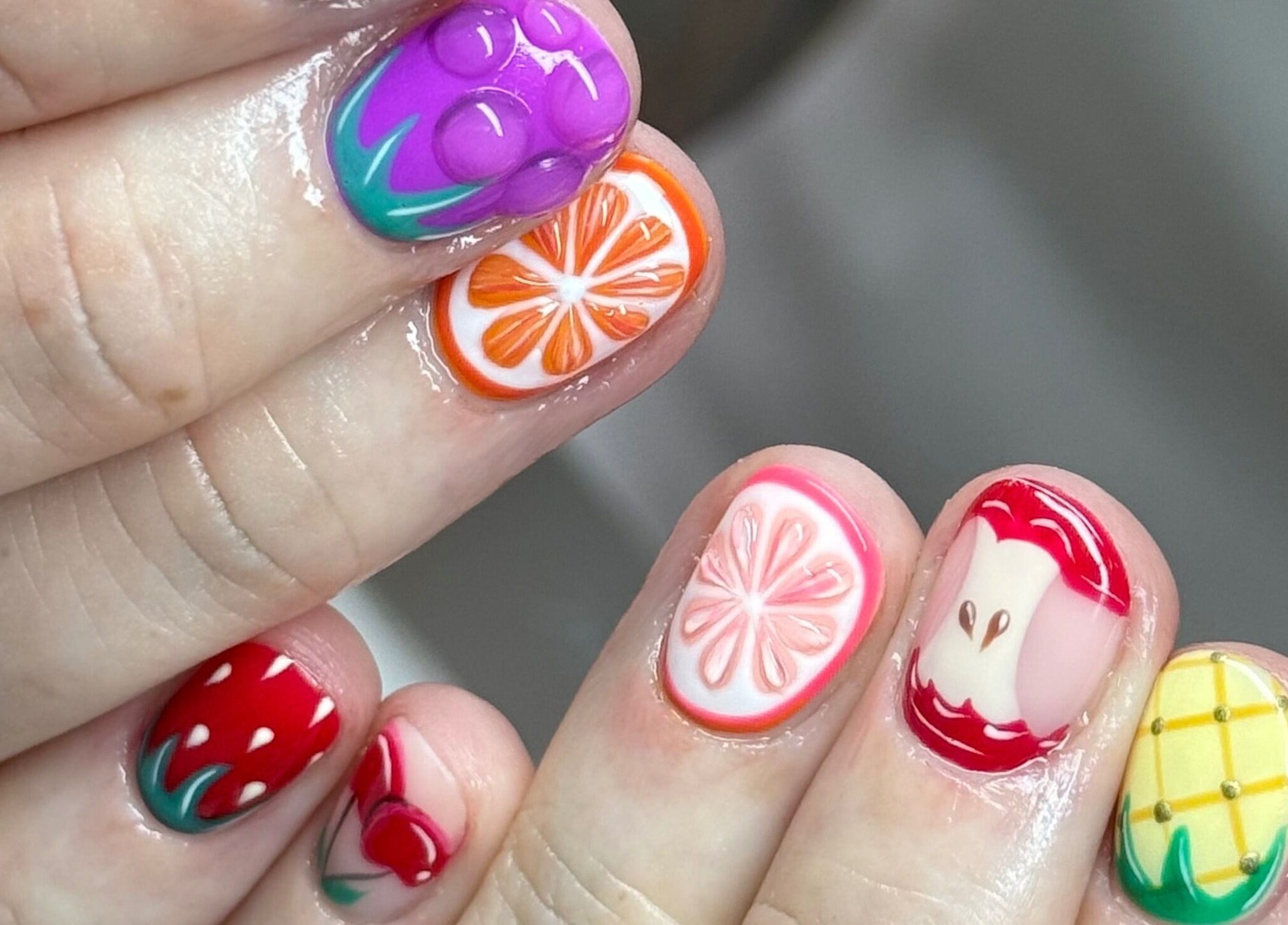 Colorful fruit nail art design at Glossy, Pontefract, England, GB.