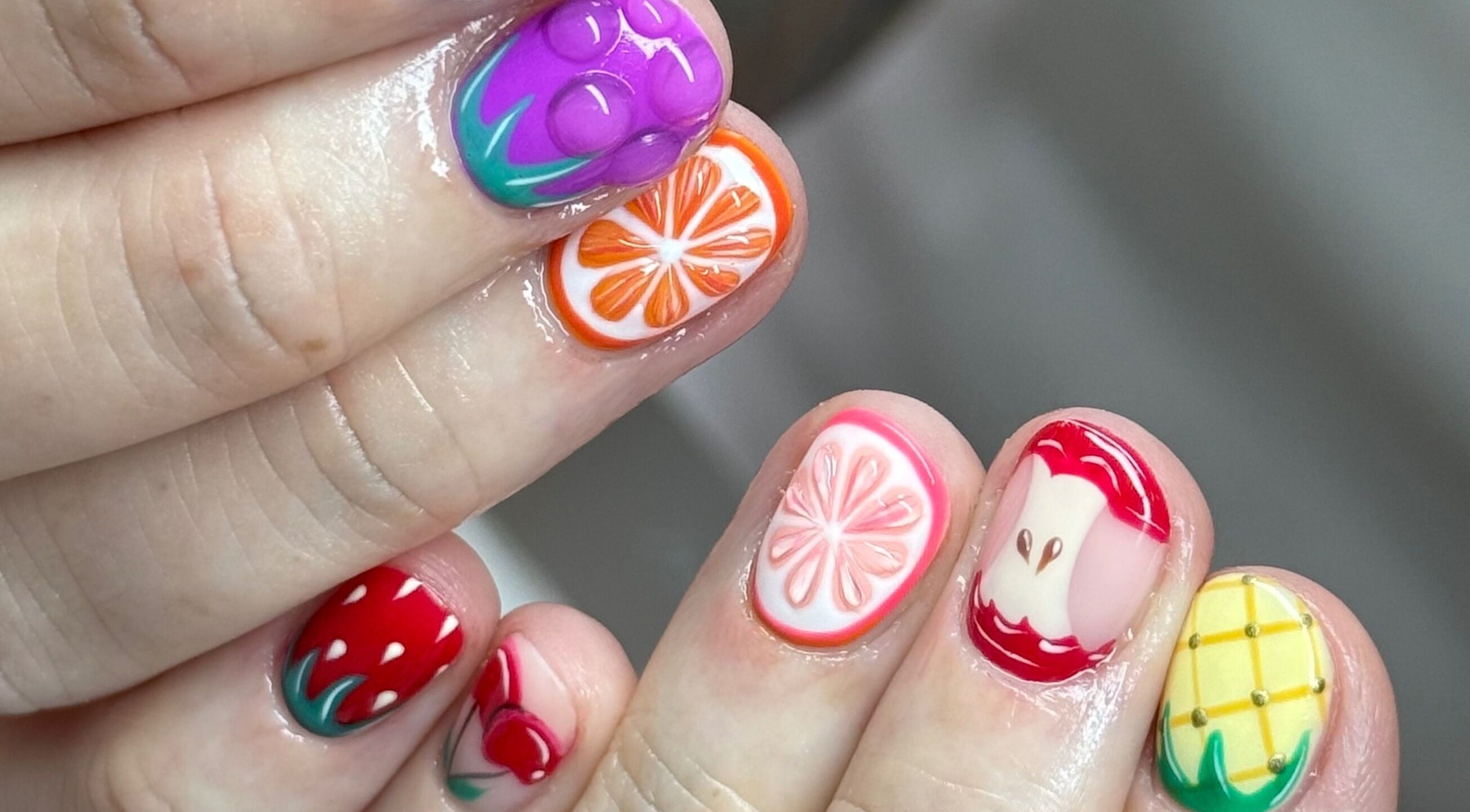Colorful fruit nail art design at Glossy, Pontefract, England, GB.