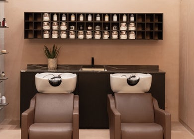 Elegant shampoo stations at Stellar Salon, Riyadh, SA, with luxurious products and modern decor.