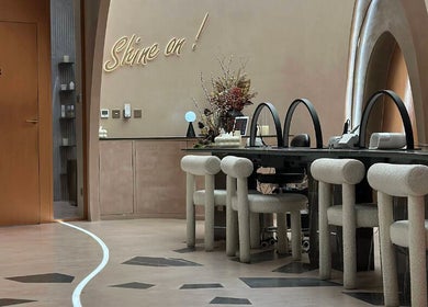 Chic modern interior of Stellar Salon in Riyadh, SA, with stylish seating and decor under soft lighting.