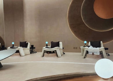 Luxurious relaxation chairs in Stellar Salon, Riyadh SA, with modern decor and subtle lighting.
