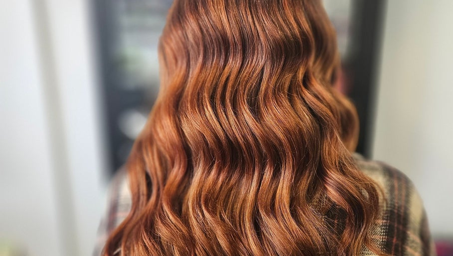 Elegant wavy red hair styling at Alexandra hair, Hucknall, England, GB.