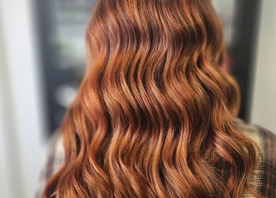 Elegant wavy red hair styling at Alexandra hair, Hucknall, England, GB.