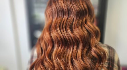 Elegant wavy red hair styling at Alexandra hair, Hucknall, England, GB.