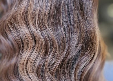 Rich, wavy brunette hair styled at Alexandra Hair in Hucknall, England, GB. Perfect shine and texture.