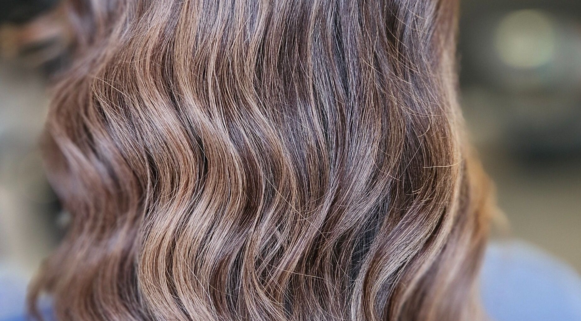 Soft, glossy brown waves styled at Alexandra Hair, Hucknall, England, GB for a natural, elegant look.