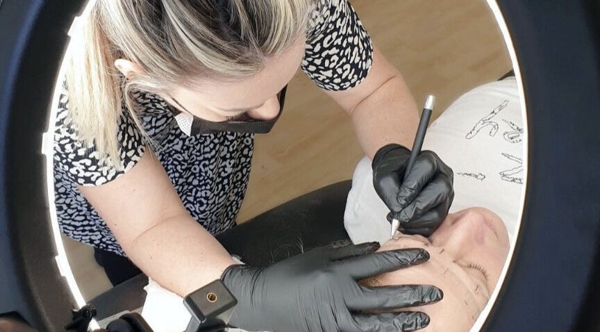 Artist crafting eyebrows at Rebecca Uddin Permanent Make Up, Dorridge, England, GB.